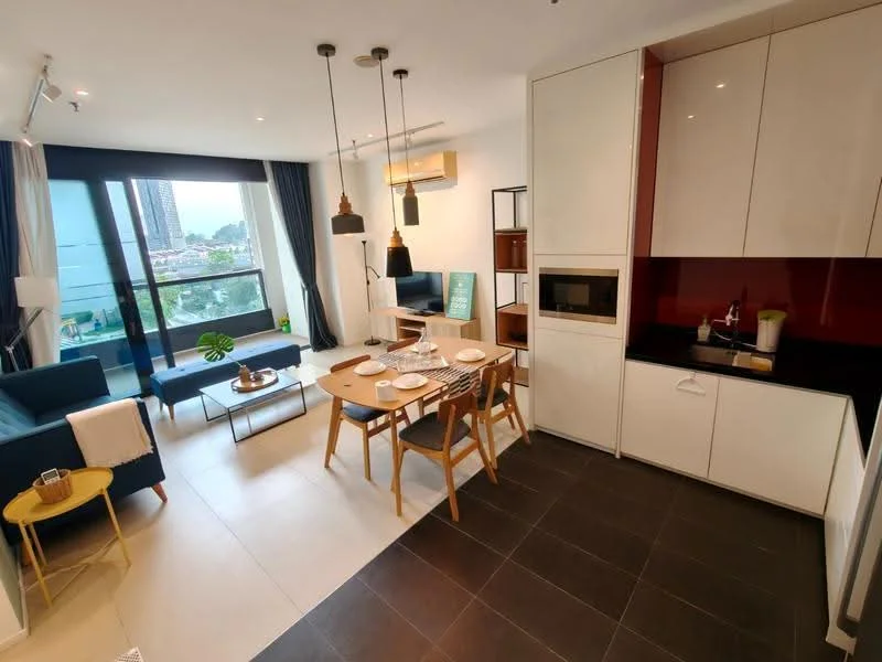 Living features: 3-seater fabric sofa in blue, coffee table, area rug, floor-to-ceiling windows, city view, wall-mounted air conditioning unit, decorative plant on side table; style: modern; view: city. Dining features: 6-seater dining table, wooden dining chairs, pendant lighting above table, wall-mounted cabinet, microwave, black countertop; style: modern. Kitchen features: white cabinetry, black countertop, built-in oven, stainless-steel sink, chrome pull-down faucet; style: modern.
