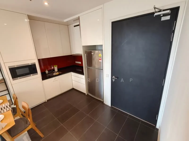 Kitchen features: white flat-panel cabinets, black granite countertop, red backsplash, stainless-steel fridge, built-in microwave, single-bowl stainless-steel sink, chrome pull-down faucet, 4-burner gas hob, dining table with checkered pattern, dark tiled flooring, door leading to hallway; style: modern.