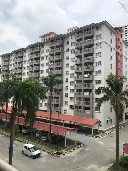 Exterior type: low-rise apartment block; features: grey painted facade, balconies with railings, red awning over parking area, covered parking spaces, palm trees in foreground, multiple storeys, visible laundry on balconies, urban setting; style: modern.