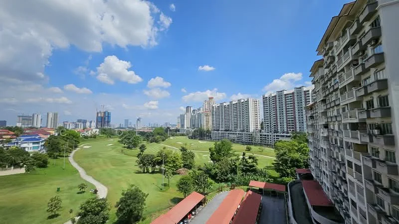 Exterior type: high-rise condominium; features: green park area, manicured lawn, surrounding trees, city skyline in background, multiple high-rise buildings, covered parking area with red awning; style: modern.