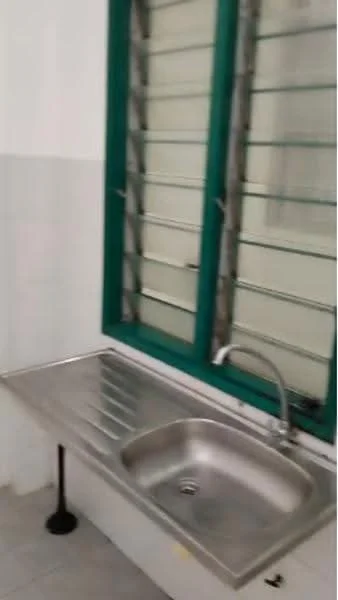 Room features: stainless-steel sink, chrome pull-down faucet, metal countertop, green window frames, louvered windows, white tiled walls, grey tiled flooring.