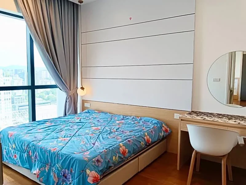 Bedroom features: queen-size bed with floral bedding, wooden bed frame, light wood bedside table, round mirror, desk with decorative table runner, white chair, floor-to-ceiling window, curtains in grey, wooden flooring, accent wall with horizontal panels; style: modern; view: city.