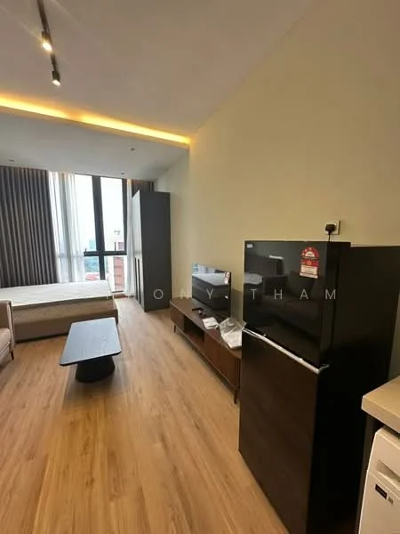 Living features: wooden flooring, light grey painted walls, floor-to-ceiling windows, black fridge, TV on console, wooden coffee table, sofa, curtains, recessed lighting, bed in background; style: modern; view: city.