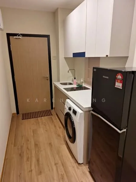 Kitchen features: white cabinetry with flat-panel doors, grey countertop, single-bowl stainless-steel sink, chrome pull-down faucet, built-in washing machine, black fridge, wooden laminate flooring, wall-mounted air conditioning unit, door with wood finish, matte black door handle, kitchen mat in front of sink; style: modern.