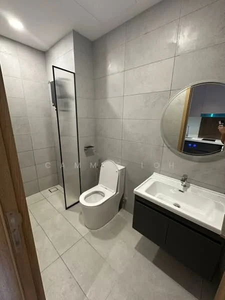 Bathroom features: grey tiled walls, grey tiled flooring, walk-in shower with glass enclosure, chrome basin mixer faucet, single-sink vanity with dark cabinetry, round mirror, one-piece toilet, built-in shower shelf; style: modern.