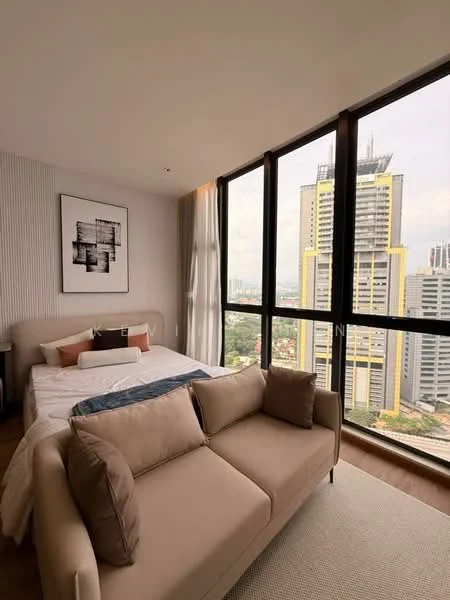 Bedroom features: king-size bed with white bedding, upholstered headboard, 2 bedside lamps, floor-to-ceiling windows, city skyline view, light wood flooring, sofa in beige fabric, decorative throw pillows, framed artwork on wall, sheer curtains; style: modern; view: city.