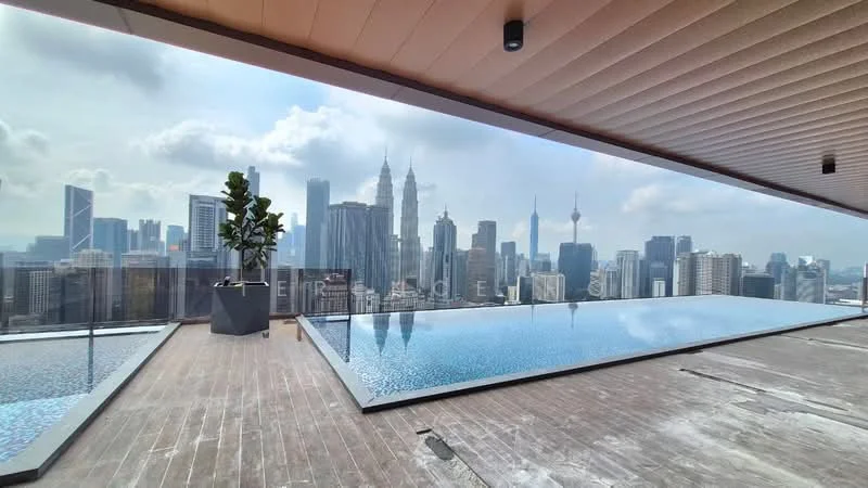 Exterior type: high-rise condominium; features: infinity pool, pool deck with loungers, glass railing, wooden decking, city skyline view, surrounded by urban landscape, planter with greenery; style: modern.