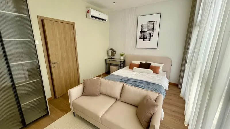Bedroom features: queen-size bed with white bedding, upholstered headboard, 2 bedside pillows, side table with decorative plant, wall-mounted mirror, study desk with chair, floor-to-ceiling windows with sheer curtains, 1 wall-mounted split AC, wooden flooring, beige fabric sofa, glass wardrobe, framed artwork on wall; style: modern.