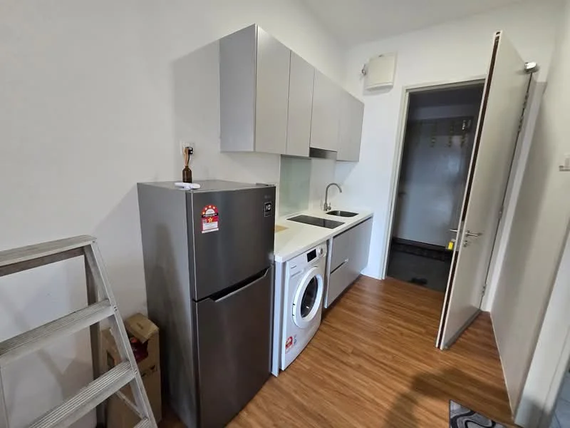 Laundry features: light wood laminate flooring, white painted walls, stainless-steel fridge, front-load washing machine, single-bowl stainless-steel sink, chrome pull-down faucet, upper cabinets with grey finish, door leading to another room; style: modern.