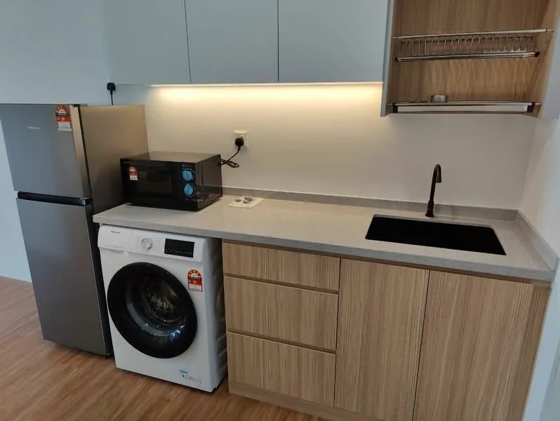 Kitchen features: stainless-steel fridge, built-in microwave, front-load washing machine, single-bowl black sink, chrome pull-down faucet, grey granite countertop, wood cabinetry, under-cabinet lighting, laminate flooring; style: modern.