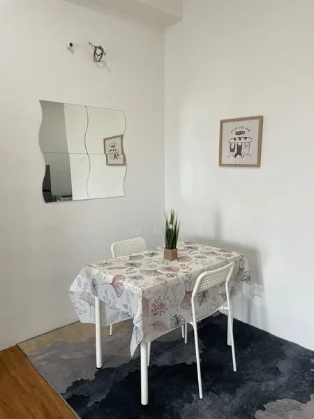 Dining features: white walls, wooden flooring, round dining table with patterned tablecloth, two white chairs, decorative plant in a pot, framed artwork on wall, mirrored wall decor, area rug with abstract pattern; style: modern.