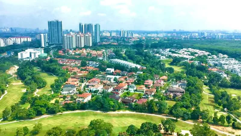 Exterior type: high-rise condominium; features: city skyline in background, lush green golf course, manicured lawns, residential houses with red roofs, multi-storey buildings, surrounded by mature trees; style: modern.