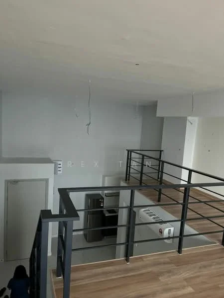 Room features: light wood flooring, white painted walls, black metal railing, exposed ceiling with wires, air conditioning unit, door leading to another room, refrigerator, open space layout; style: modern.