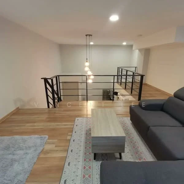 Living features: grey fabric sectional sofa, wooden coffee table, area rug with geometric pattern, wooden flooring, recessed downlights, hanging pendant light fixture, open railing, neutral painted walls; style: modern.