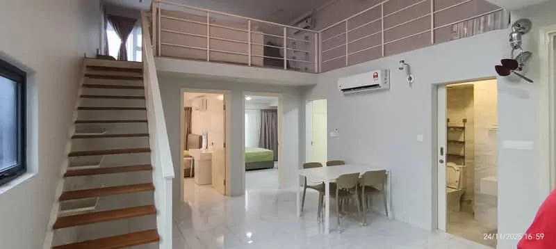 Living features: white painted walls, marble tile flooring, 5-blade ceiling fan, wall-mounted split AC, dining table with four chairs, staircase with wooden steps, glass railing, large window with dark frame; style: modern. Bedroom features: green bedspread, bedside table, curtains, carpet flooring, wall-mounted light fixture. Bathroom features: tile cladding, one-piece toilet, sink with faucet, mirror, shower area.