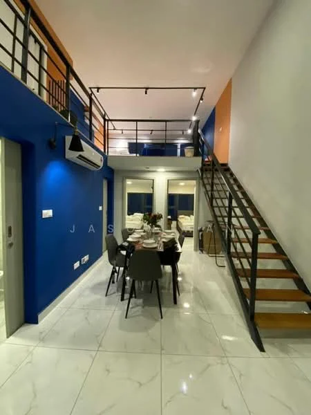 Dining features: marble tile flooring, blue painted walls, white ceiling, 5-blade ceiling fan with light, dining table for six, upholstered dining chairs, decorative vase with flowers, wall-mounted air conditioning unit, staircase with wooden steps and metal railing, large windows with natural light; style: modern. Living features: white walls, large windows, sofa visible in background, open layout, high ceiling; style: modern.