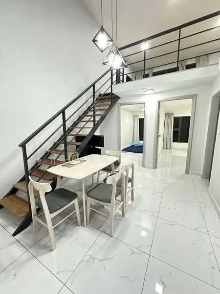Dining features: white dining table, 4 upholstered dining chairs in grey, marble tile flooring, pendant lighting with geometric design, open staircase with wooden steps and metal railing, white painted walls, large windows with sheer curtains; style: modern. Living features: sofa visible in background, TV console visible in background, marble tile flooring, white painted walls, large windows with sheer curtains; style: modern. Bedroom features: bed visible in background, white painted walls, large windows with sheer curtains; style: modern.
