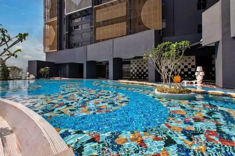 Exterior type: high-rise condominium; features: infinity pool, pool deck with loungers, tropical landscaping, decorative planters, water features, checkerboard pattern tiles, surrounding greenery, modern architecture, glass facade, outdoor seating area; style: modern.