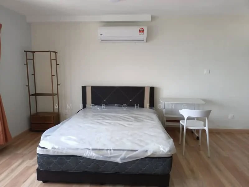 Bedroom features: queen-size bed, wooden bed frame, mattress with protective cover, 1 wall-mounted split AC, wooden bedside table, white study desk, white chair, laminate flooring, orange curtains, plain white walls; style: modern.