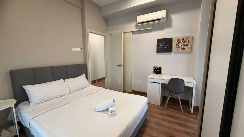 Bedroom features: queen-size bed with grey upholstered headboard, white bedding, wooden flooring, wall-mounted air conditioning unit, desk with white surface, grey chair, light grey painted walls, framed artwork on wall, door to hallway, window with natural light; style: modern.