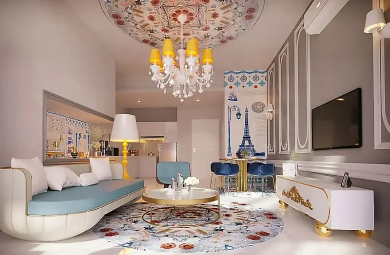Living features: sofa with blue upholstery and white cushions, round coffee table with gold accents, decorative area rug with floral pattern, chandelier with yellow shades, wall-mounted TV, feature wall with decorative wallpaper, ceiling with intricate design, recessed lighting, floor-to-ceiling windows, air conditioning unit; style: modern.
