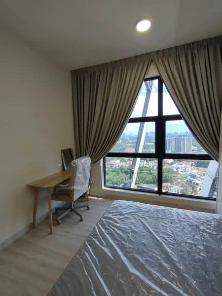 Bedroom features: large triangular window, floor-to-ceiling windows, grey curtains, wooden desk, white office chair, light wood flooring, neutral wall color, city view; style: modern; view: city.