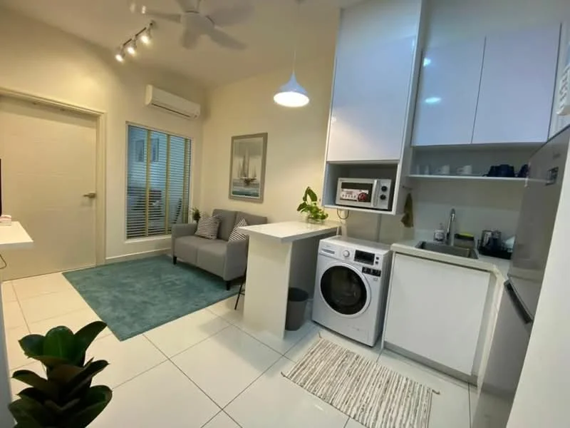 Living features: light grey fabric sofa, white coffee table, area rug in teal, wall-mounted TV, recessed LED downlights, ceiling fan, white painted walls, sliding glass door, window with blinds, decorative plant in ceramic pot; style: modern. Laundry features: front-load washing machine, white cabinetry, microwave, countertop with storage, stainless-steel sink, tile flooring; style: modern.