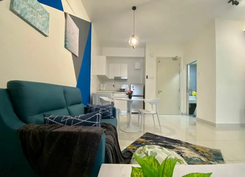 Living features: teal fabric sofa, white coffee table, area rug with abstract pattern, pendant light fixture, wall-mounted artwork, white tiled flooring, dining table with 3 white chairs, open kitchen area, green indoor plant, sliding door to utility area; style: modern.