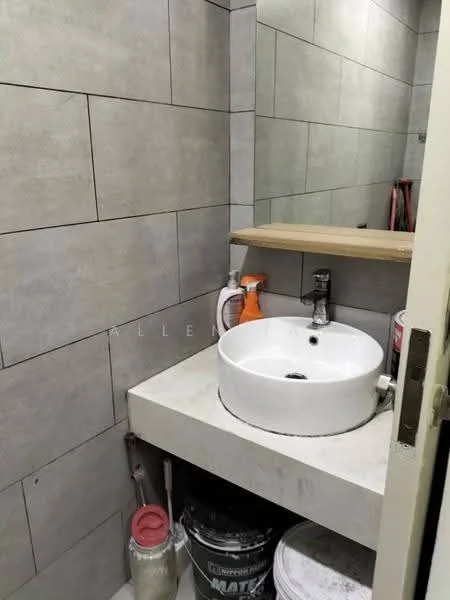 Bathroom features: grey tiled walls, white circular sink, chrome faucet, wooden shelf above sink, concrete countertop, paint buckets visible, cleaning supplies visible, mirror above sink; style: modern.