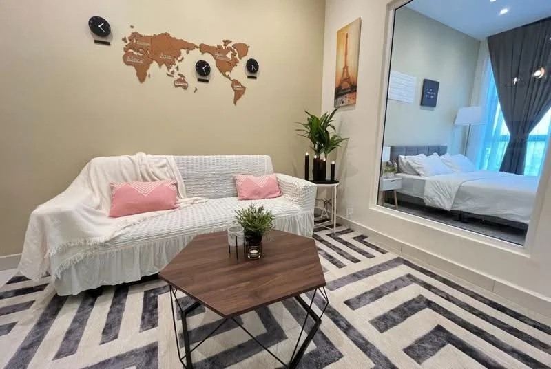 Living features: white sofa with throw blanket, pink decorative pillows, wooden coffee table, area rug with geometric pattern, wall-mounted world map decor, potted plant, large mirror reflecting bedroom, floor-to-ceiling windows with curtains, grey accent wall, recessed lighting; style: modern.