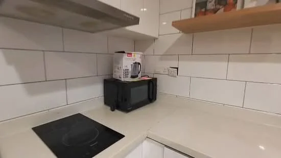 Kitchen features: white tiled backsplash, cream countertop, black microwave, induction cooktop, white cabinets, open shelving, built-in appliances, under-cabinet lighting; style: modern.