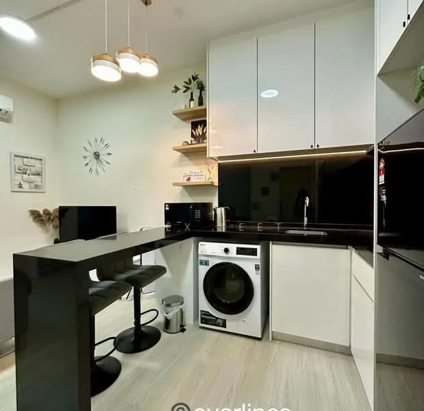 Laundry features: black countertop, white cabinetry, built-in shelves, front-load washing machine, stainless-steel sink, chrome pull-down faucet, 2 bar stools, wall-mounted TV, recessed LED downlights, decorative wall clock, cream painted walls, vinyl plank flooring; style: modern.