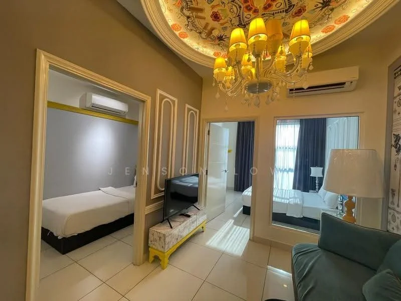Room features: white walls, glossy white floor tiles, tray ceiling with floral design, chandelier with multiple bulbs, 1 wall-mounted split AC, large window with sheer curtains, TV on stand, green upholstered armchair, yellow accent table, two beds visible in separate areas; style: modern.