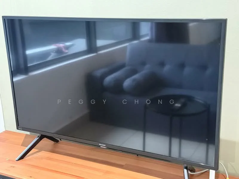 Room features: flat-screen TV, wooden TV console, grey upholstered sofa, side table, large windows, neutral wall color, tile flooring; style: modern.