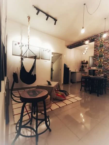 Living features: hammock chair, round coffee table, stool, area rug with geometric pattern, wall-mounted lighting, open kitchen area, decorative wall with colorful pattern, ceramic tile flooring, white painted walls, kitchen counter with bar stools; style: modern.