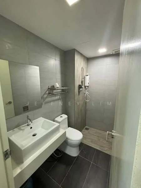 Bathroom features: grey tiled walls, light grey floor tiles, single-sink vanity with rectangular basin, chrome basin mixer faucet, wall-mounted mirror, toilet, shower area with handheld shower, wall-mounted shower head, towel rack, exhaust fan, built-in shelving; style: modern.