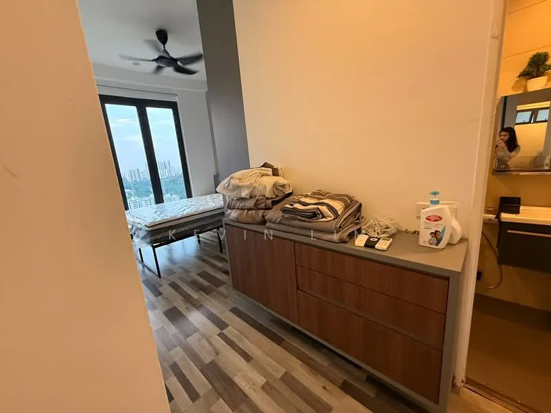 Room features: wooden flooring, grey painted walls, ceiling fan, large windows with city view, bed frame, bedding, dresser with drawers, laundry detergent, remote control, bathroom door, mirror reflection visible; style: modern; view: city.