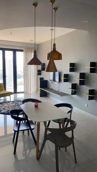 Dining features: white dining table, 4 dining chairs in black and grey, 3 pendant lights in gold, grey accent wall, floor-to-ceiling windows, sheer curtains, decorative wall shelves in black with yellow accents, area rug with geometric pattern, TV mounted on wall, decorative candle on table, tile flooring; style: modern; view: city.
