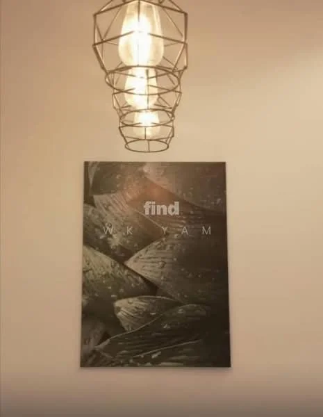 Room features: pendant light with geometric design, framed artwork with abstract pattern, white painted walls; style: modern.