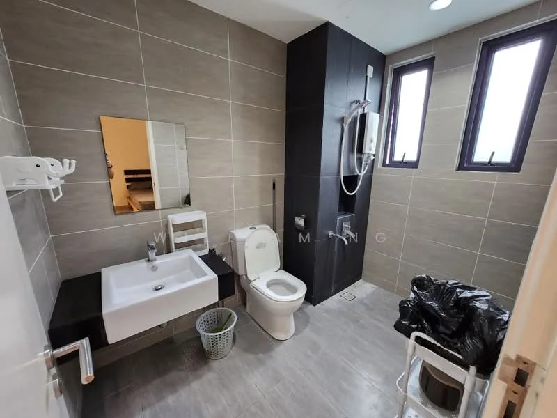 Bathroom features: grey ceramic tile flooring, light grey wall tiles, dark grey accent wall, single-sink vanity with white cabinet, chrome basin mixer faucet, framed mirror, one-piece toilet, walk-in shower with glass enclosure, rain shower head, two windows, white laundry basket, plastic garbage bag, white folding chair; style: modern.