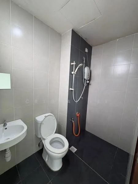 Bathroom features: white ceramic toilet, wall-mounted shower with adjustable height, chrome showerhead, orange shower hose, small wall-mounted sink, mirror above sink, grey tiled walls, black tiled flooring; style: modern.