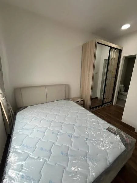 Bedroom features: queen-size bed with mattress, upholstered headboard, built-in wardrobe with mirrored doors, wooden flooring, white painted walls, window with sheer curtains, nightstand, recessed ceiling light; style: modern.