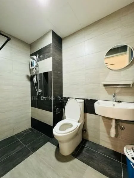 Bathroom features: white toilet, single-sink vanity with wall-mounted faucet, round mirror, shower with handheld showerhead, black and beige tile cladding, grey floor tiles, wall-mounted shelf, glass shower partition; style: modern.