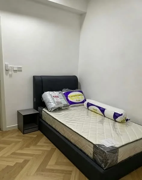Bedroom features: queen-size bed, upholstered headboard, nightstand, laminate flooring, white painted walls, decorative pillows, mattress with protective cover, window with no visible treatment; style: modern.