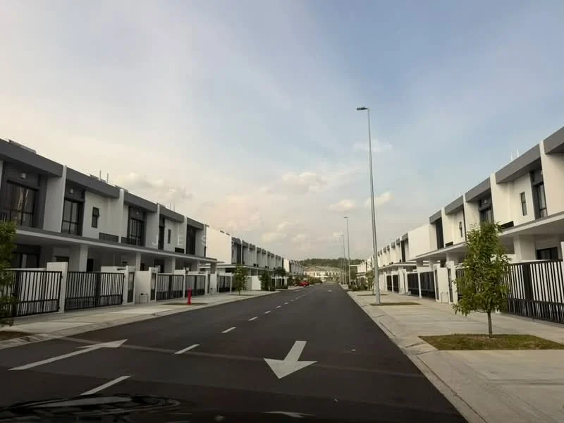 Exterior type: linked terrace house; features: modern facade with white and grey cladding, two-storey buildings, manicured landscaping with small trees, paved walkway, street lighting, asphalt road, fenced front yards, driveways for each unit, open space between buildings, clear blue sky; style: modern.
