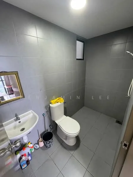 Bathroom features: grey tiled walls, grey tiled flooring, white toilet, wall-mounted sink, chrome faucet, framed mirror, window for natural light, cleaning supplies, small trash bin; style: modern.
