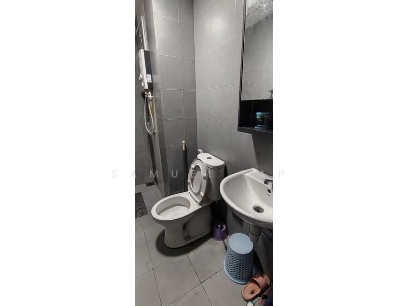 Bathroom features: grey tiled walls, grey tiled flooring, one-piece toilet, sink with pedestal, chrome basin mixer faucet, mirror above sink, shower area with wall-mounted showerhead, laundry basket, pink stool; style: modern.