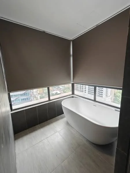 Bathroom features: freestanding bathtub, floor-to-ceiling windows, roller blinds, grey tile flooring, dark wall tiles, city view, modern design; style: modern; view: city.
