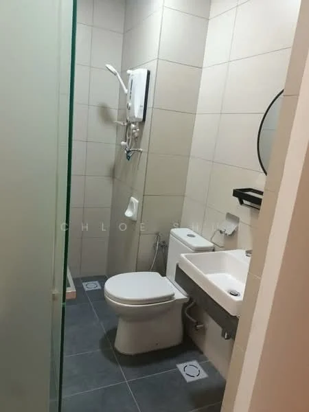 Bathroom features: grey ceramic tile flooring, white tiled walls, round mirror, single-sink vanity with white cabinet, chrome basin mixer faucet, one-piece toilet, shower area with glass enclosure, wall-mounted shower head, towel holder, toilet paper holder; style: modern.