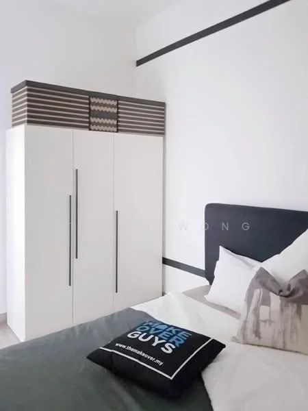 Bedroom features: white painted walls, grey accent wall, queen-size bed with grey bedding, upholstered headboard, decorative throw pillows, built-in wardrobe with white finish, black and white decorative box on top of wardrobe, wooden flooring, bedside table, table lamp; style: modern.